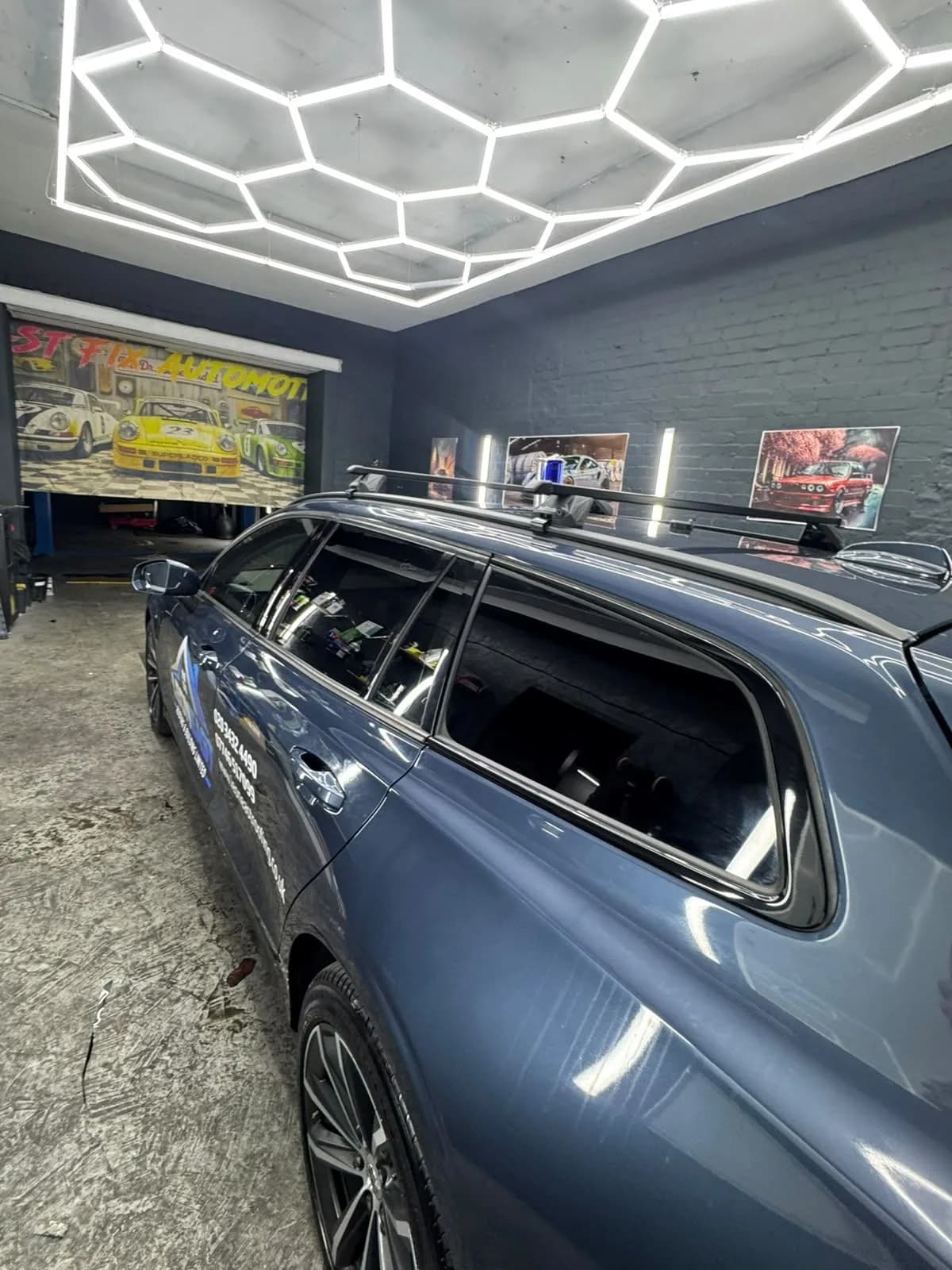 Blue estate car with tinted side windows